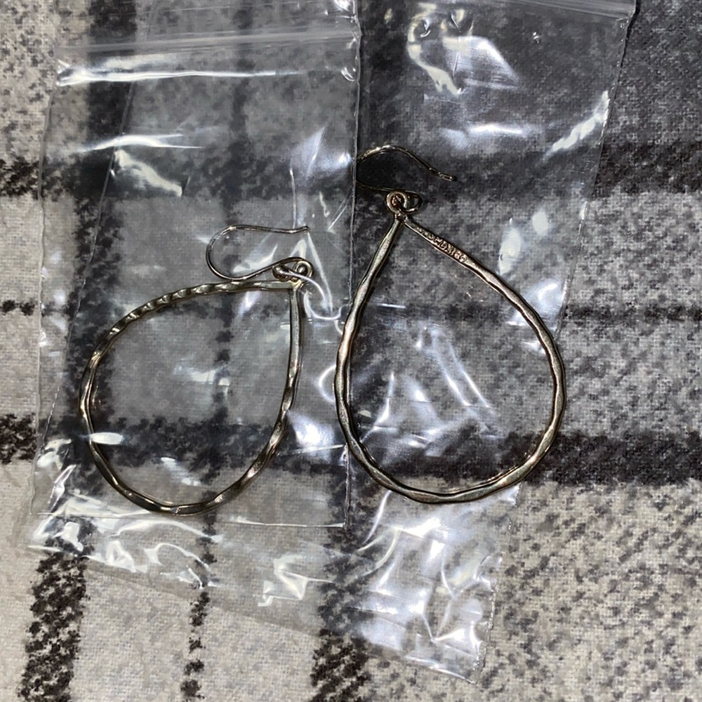Woman’s silver teardrop dangle earrings